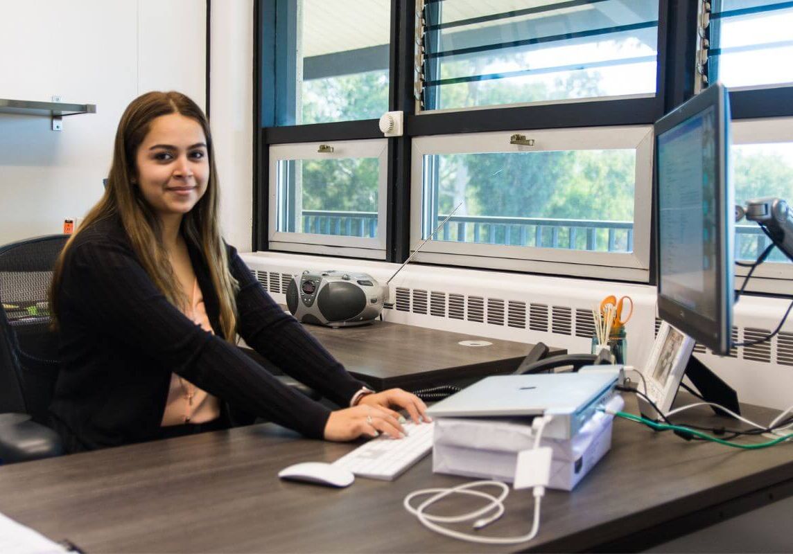 woman sitting at desk typing